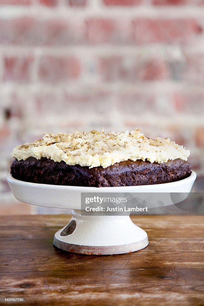 BANANA CAKE DECORATED WITH CREAM AND WALNUT PIECES