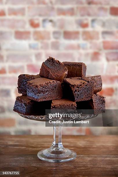 pile of chocolate brownies on cake stand - brownie stock pictures, royalty-free photos & images