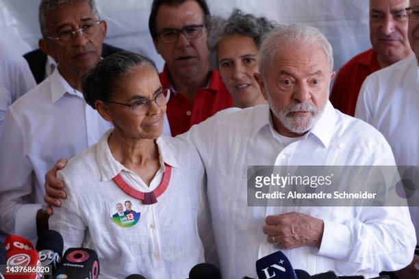 Candidate Luiz Inácio Lula Da Silva of Workers’ Party stands next to politician Marina Silva during a press conference after casting his vote at...
