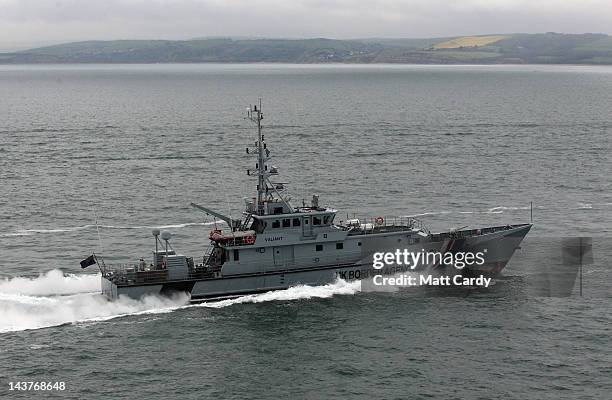 Border Agency boat passes HMS Bulwark as it takes part in a security exercise off the coast of Weymouth and Portland on May 3, 2012 in Portland,...