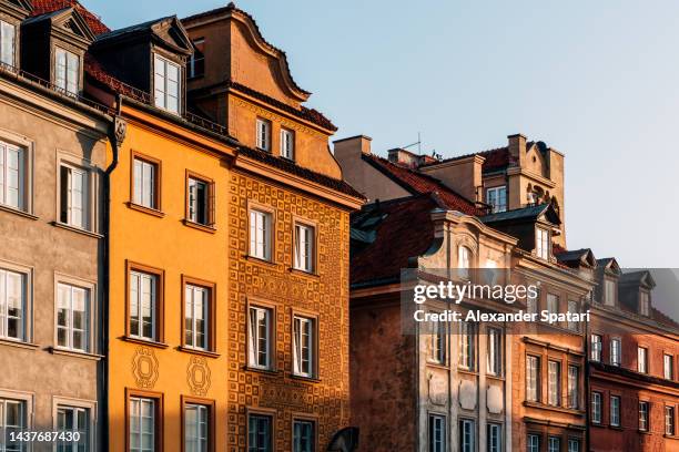 house facade lit by the sun in warsaw old town, poland - house golden hour stock pictures, royalty-free photos & images