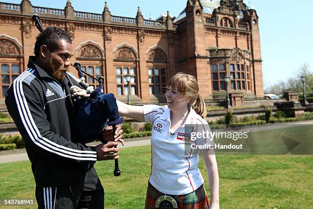 In this handout image provided by HSBC, Lote Raikabula from New Zealand Sevens learns to play the bagpipes ahead of the HSBC Sevens World Series on...