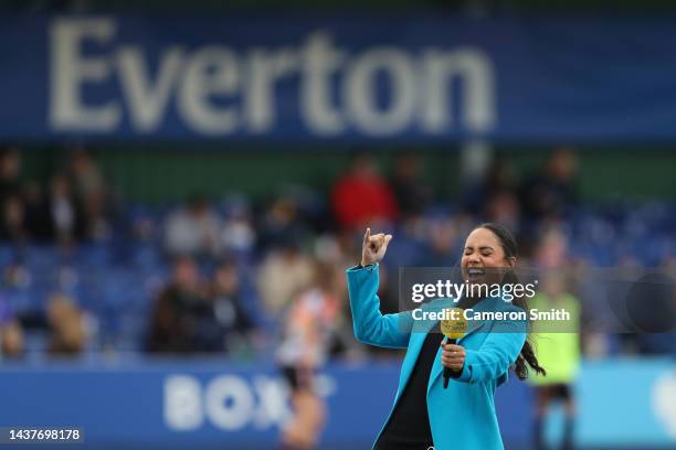 Alex Scott, presenter and former footballer, reacts prior to kick off of the FA Women's Super League match between Everton FC and Manchester United...