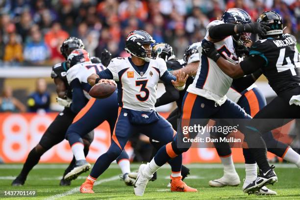 Russell Wilson of the Denver Broncos looks to throw a pass in the first half during the NFL match between Denver Broncos and Jacksonville Jaguars at...