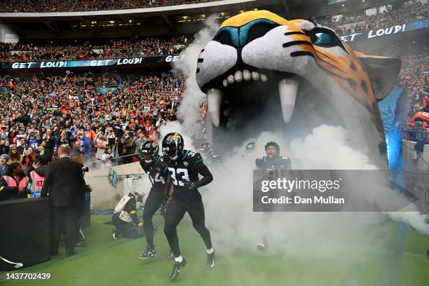 Travon Walker, Devin Lloyd and Dawuane Smoot of the Jacksonville Jaguars take to the field prior to the NFL match between Denver Broncos and...