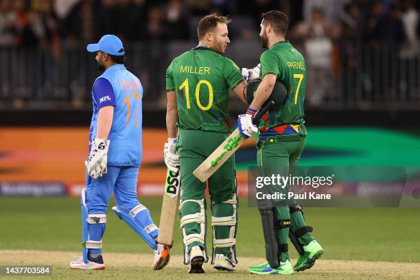 David Miller and Wayne Parnell of South Africa celebrate winning the ICC Men's T20 World Cup match between India and South Africa at Perth Stadium on...