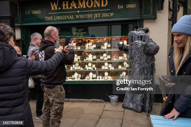 Person in costume poses for pictures as they attend Whitby Goth Weekend on October 30, 2022 in Whitby, England. The Whitby Goth weekend began in 1994...