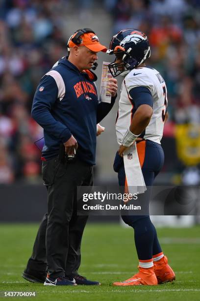 Nathaniel Hackett, Head Coach of the Denver Broncos speaks with Russell Wilson during the NFL match between Denver Broncos and Jacksonville Jaguars...