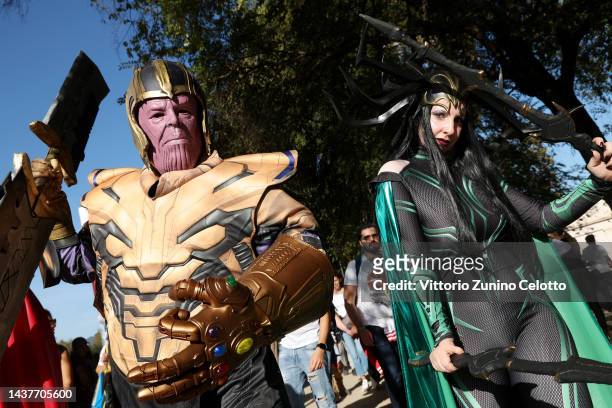 Thanos and Hela cosplayers from Marvel Cinematic Universe pose during the 56th Lucca Comics & Games 2022 on October 30, 2022 in Lucca, Italy.