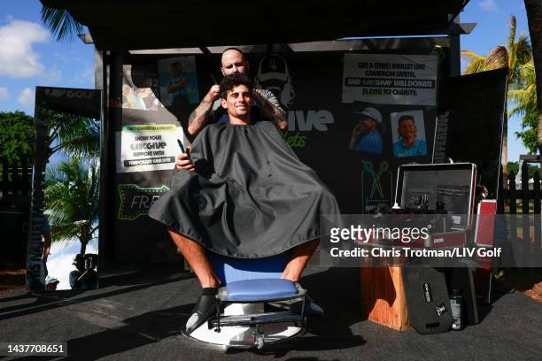 Team Captain Joaquín Niemann of Torque GC gets a mullet haircut at the LIV to Give Mullets charity booth during the team championship stroke-play...