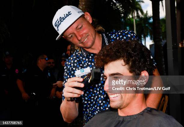 Team Captain Joaquín Niemann of Torque GC gets a mullet haircut from team Captain Cameron Smith of Punch GC at the LIV to Give Mullets charity booth...