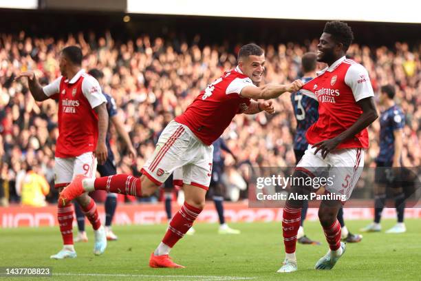 Thomas Partey of Arsenal celebrates with teammate Granit Xhaka after scoring their team's fourth goal during the Premier League match between Arsenal...