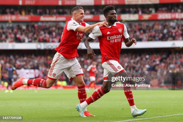 Thomas Partey of Arsenal celebrates with teammate Granit Xhaka after scoring their team's fourth goal during the Premier League match between Arsenal...