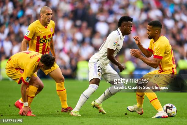 Vinicius Junior of Real Madrid battle for the ball with Yangel Herrera of Girona CF during the LaLiga Santander match between Real Madrid CF and...