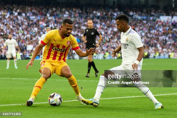 Rodrygo Goes of Real Madrid is challenged by Yangel Herrera of Girona FC during the LaLiga Santander match between Real Madrid CF and Girona FC at...