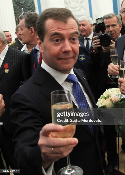 Russian President Dmitry Medvedev holds a glass of champagne as he hosts an awards ceremony at the Kremlin on May 3, 2012 in Moscow, Russia,