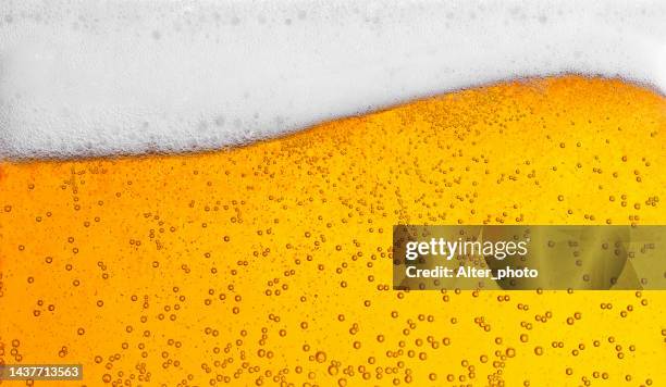 pouring beer with bubbles for background and wave shape texture foam