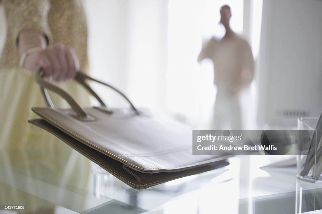 Business couple prepare to leave for meeting