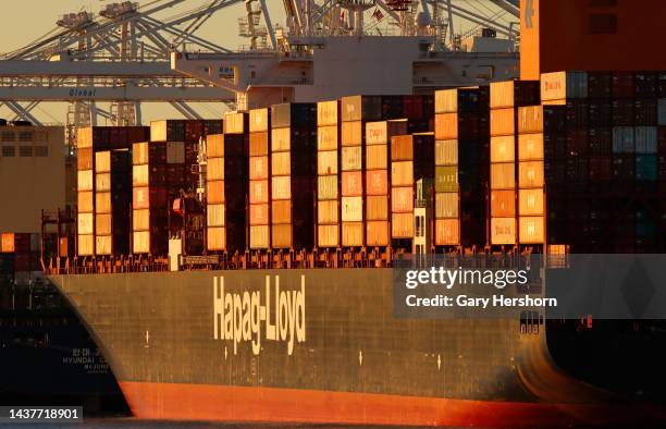 The Hapag-Lloyd Ain Snan Express container ship is unloaded at the GCT container terminal as the sun sets on October 29 in Bayonne, New Jersey.