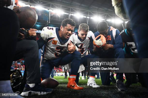 Russell Wilson of the Denver Broncos leads a prayer following their side's victory in the NFL match between Denver Broncos and Jacksonville Jaguars...