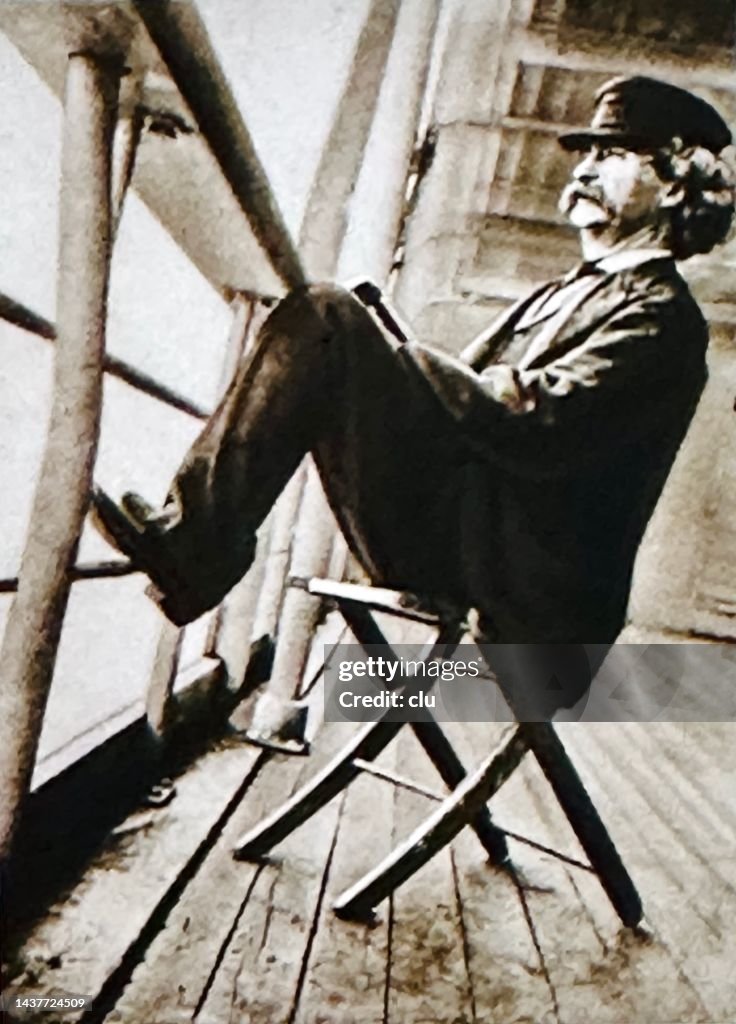 Mark Twain sitting on a chair on deck of a cruise ship