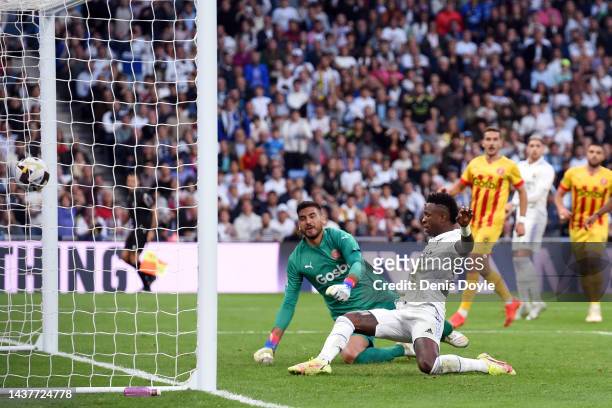 Vinicius Junior of Real Madrid scores their team's first goal past Paulo Gazzaniga of Girona FC during the LaLiga Santander match between Real Madrid...