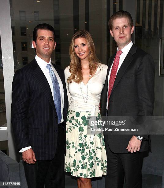 Donald Trump, Jr., Ivanka Trump and Eric Trump pose for pictures at Trump Tower on May 3, 2012 in New York City.