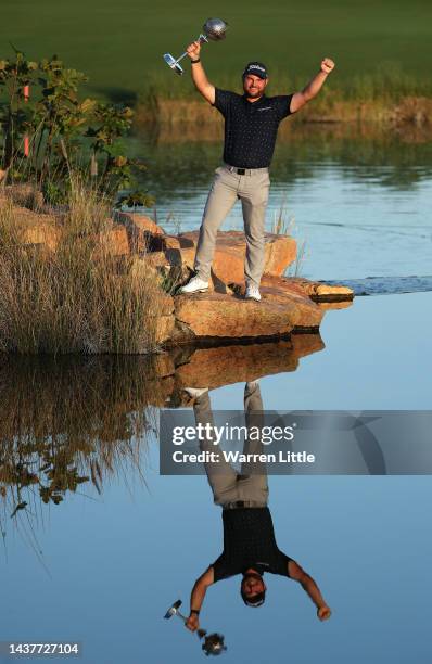 Jordan Smith of England poses for a photograph with the trophy after winning the Portugal Masters during Day Four of the Portugal Masters at Dom...