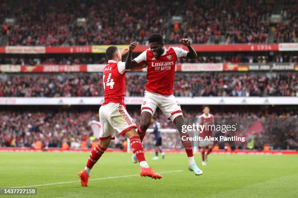 Thomas Partey of Arsenal celebrates with team mate Granit Xhaka after scoring his sides fourth goal during the Premier League match between Arsenal...