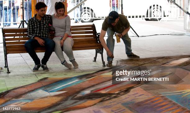 British artist Julian Beever , specialized in pavement drawings, wall murals and realistic paintings, works on May 3, 2012 in Santiago. Beever...
