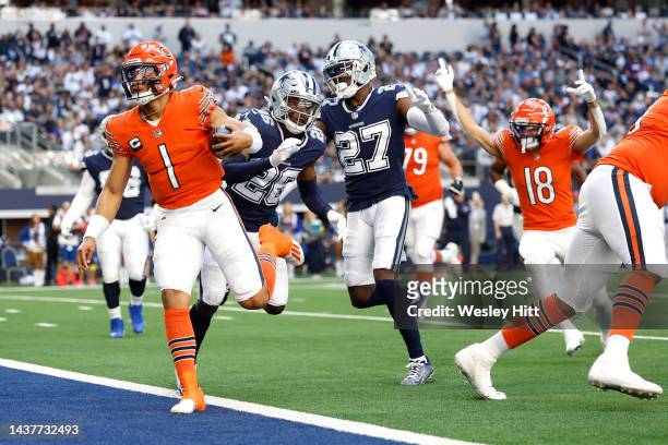 Justin Fields of the Chicago Bears rushes for a touchdown against Jayron Kearse of the Dallas Cowboys during the second quarter at AT&T Stadium on...