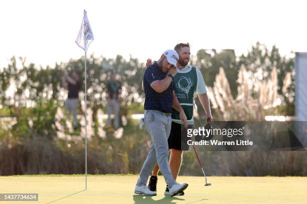 Caddie Sam Matton congratulates Jordan Smith of England on the 18th green after winning the Pir during Day Four of the Portugal Masters at Dom Pedro...