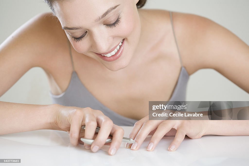 Woman removing her cuticles