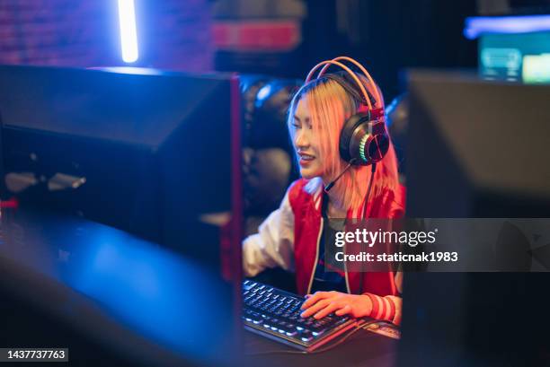 pro gamer asian female participating in online games tournament. - microsoft media & entertainment group stock pictures, royalty-free photos & images