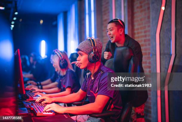 asian emcee introduces esports team players on stage. - awards ceremony poster stock pictures, royalty-free photos & images