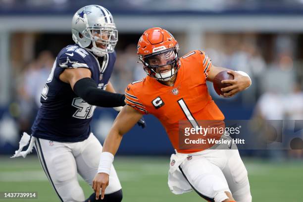 Justin Fields of the Chicago Bears rushes against Anthony Barr of the Dallas Cowboys during the first half at AT&T Stadium on October 30, 2022 in...