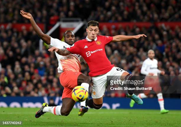 Lisandro Martinez of Manchester United is challenged by Michail Antonio of West Ham United during the Premier League match between Manchester United...