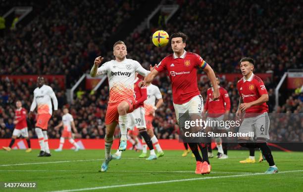 Harry Maguire of Manchester United and Jarrod Bowen of West Ham United battle for the ball during the Premier League match between Manchester United...