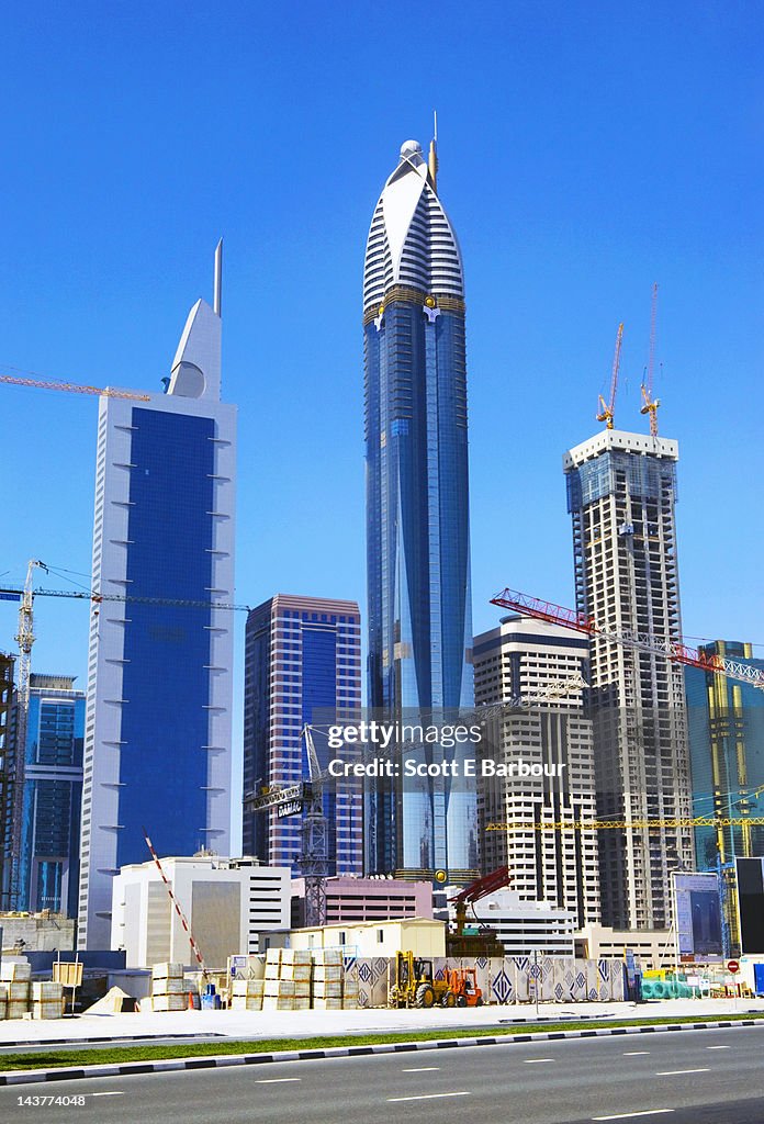 Cranes, skyscrapers under construction. Dubai
