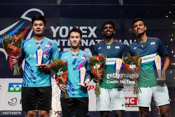 Lu Ching Yao and Yang Po Han of Chinese Taipei, Satwiksairaj Rankireddy and Chirag Shetty of India pose with their trophies on the podium after the...