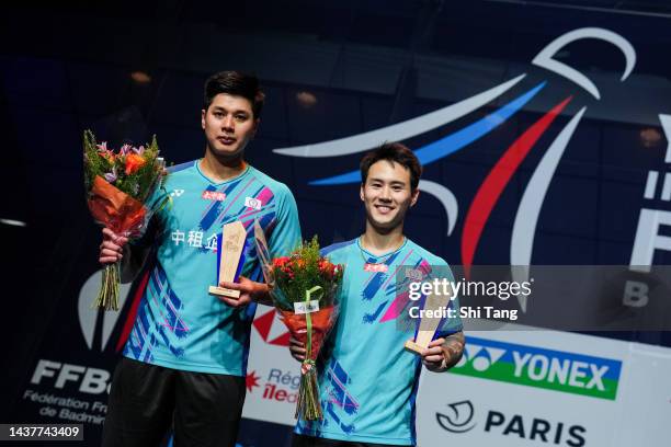 Lu Ching Yao and Yang Po Han of Chinese Taipei pose with their trophies on the podium after the Men's Double Final match against Satwiksairaj...