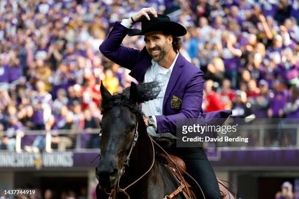 Jared Allen, former defensive end of the Minnesota Vikings, celebrates as he is inducted into the Vikings' Ring of Honor during halftime at U.S. Bank...