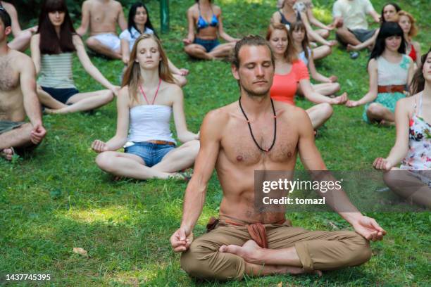 large group meditating in nature - teenager meditating stock pictures, royalty-free photos & images