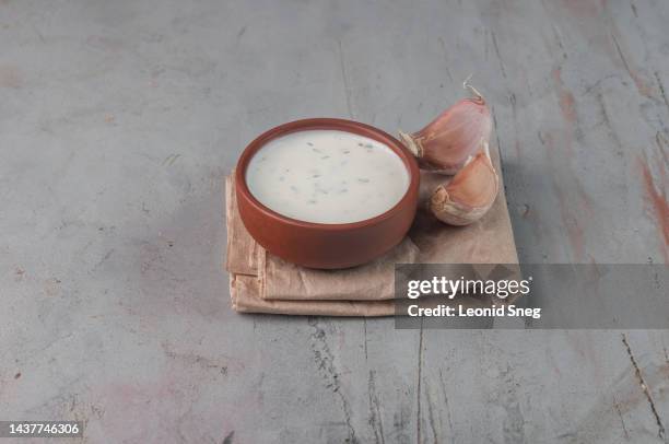 creamy garlic sauce on gray background - aioli stock-fotos und bilder