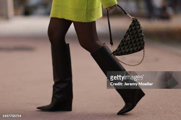 Sonia Lyson, bag detail, wearing Prada triangle olive black bag, Acne Studios olive headband, Storets neon green oversized sweater, Saint Laurent...