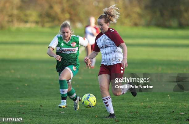 Charlotte Murphy of Northampton Town moves forward with the ball away from Emma Robinson of Kettering Tow during the East Midlands Womens Regional...