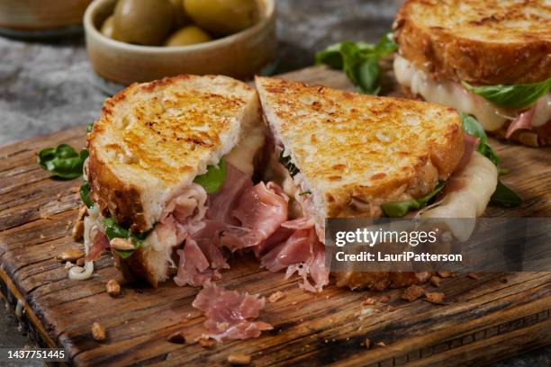 grilled cheese with prosciutto and brie - ham salami stockfoto's en -beelden