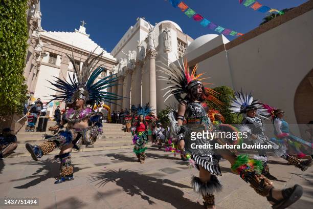 Traditional Aztec dancers perform outside the mausoleum during the Día de Los Muertos celebrations at the Catholic Cemeteries & Mortuaries in Los...