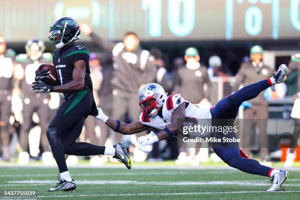 Denzel Mims of the New York Jets runs with the ball as Mack Wilson Sr. #30 of the New England Patriots defends during the second half at MetLife...