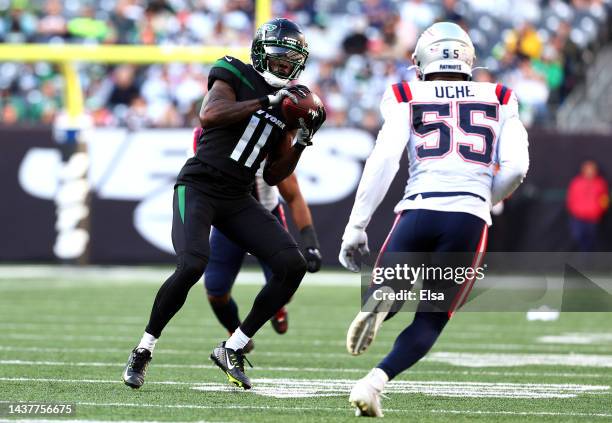 Denzel Mims of the New York Jets catches the ball as Josh Uche of the New England Patriots defends during the second half at MetLife Stadium on...